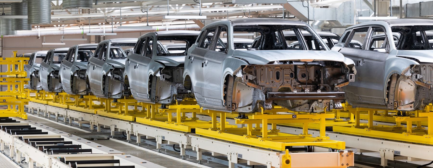 Image of car parts on a factory conveyor belt